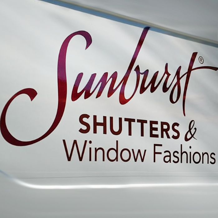 Up close shot of Sunburst Blinds logo on utility van.