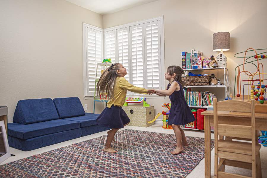 Choose Polywood shutters for durable, kid-friendly great room window treatments in Atlanta. Polywood shutters on multiple windows in a sitting area