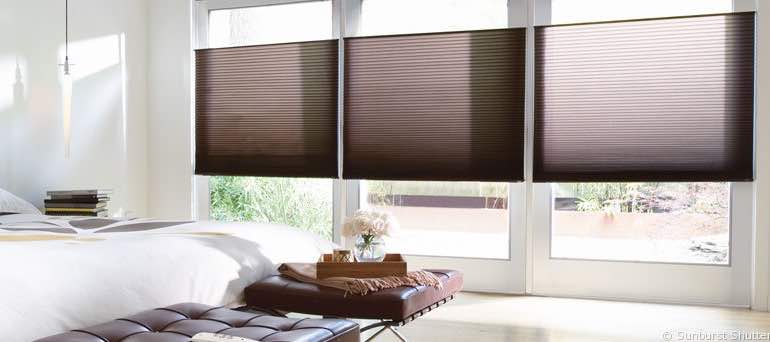 Minimal Atlanta bedroom with high windows and vertical honeycomb shades.