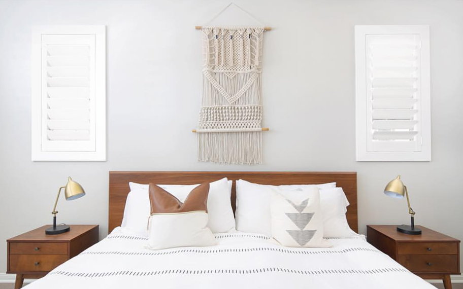 Custom-fitted louvered shutters provide excellent nighttime privacy in Atlanta. Photo Credit: Audrey Crisp Louvered shutters in a bedroom.