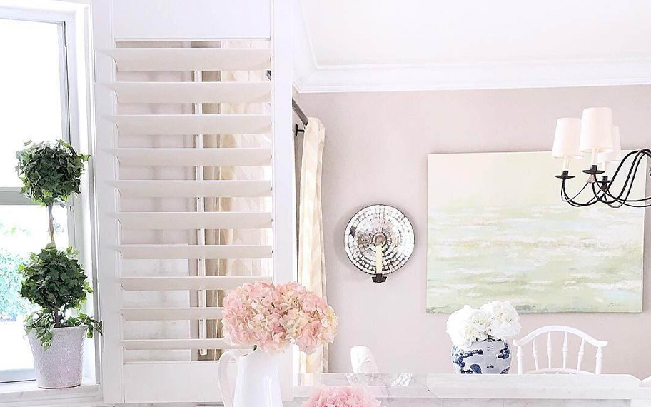 White Polywood shutters above a kitchen sink.