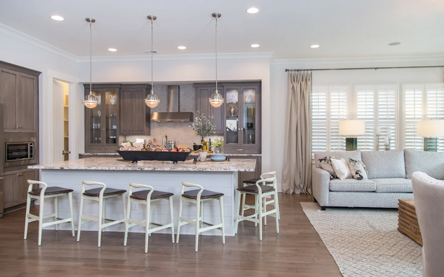 Illuminate your home with custom interior shutters in Atlanta. White arched shutters in a white kitchen with lots of light.