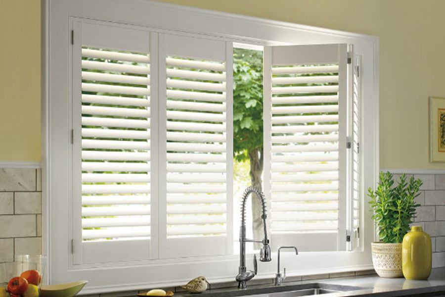 Polywood shutters are built to withstand the test of time in Atlanta. White Polywood shutters above a kitchen sink.