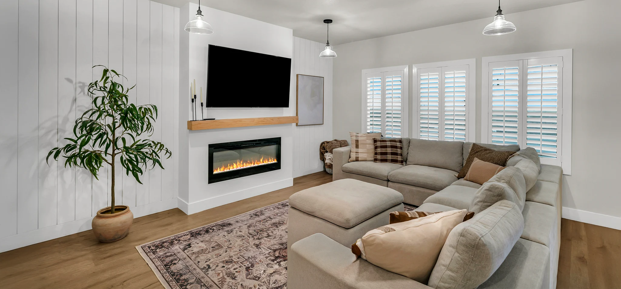 White Polywood shutters in a cozy white and wooden features in a medium size living room 