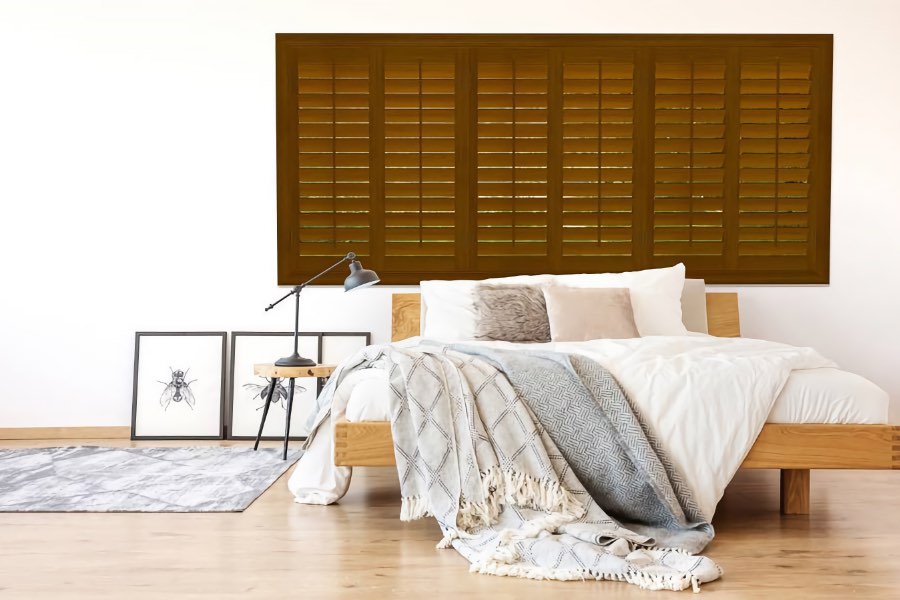 Window treatment experts will help you find the right solution for any room, like these beautiful wood plantation shutters. Wood plantation shutters in bedroom