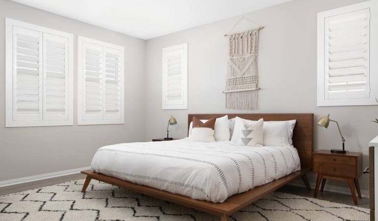 Open shutter louvers will help any Atlanta room feel larger. Plantation shutters in a model home bedroom.