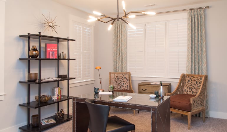 Picking the right window treatments can result in an increase in natural light. Atlanta home office with plantation shutters.