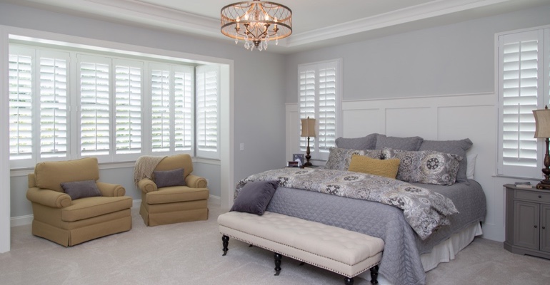 Indoor shutters offer subtle fashion. White shutters in Atlanta bedroom.