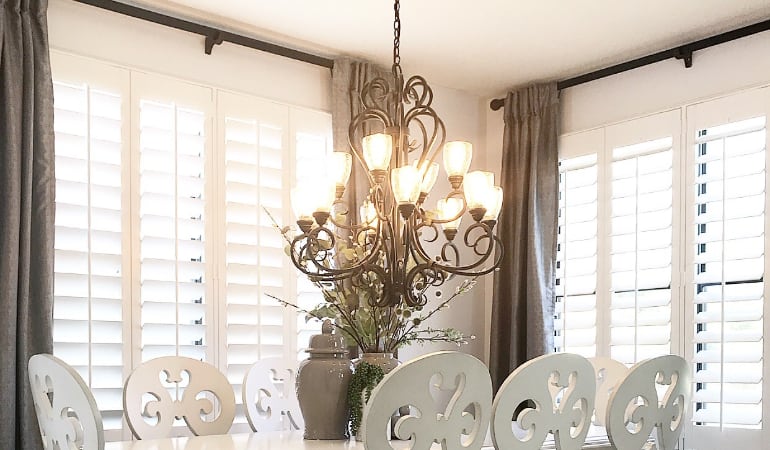 Plantation shades have wide louvers that makes them easier to clean. Plantation shades in a dining room.