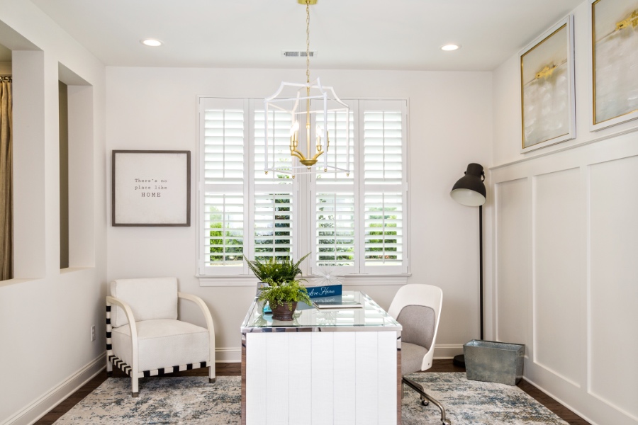 Use a feather duster to easily wipe down our durable white Polywood shutters. Office with white polywood shutters