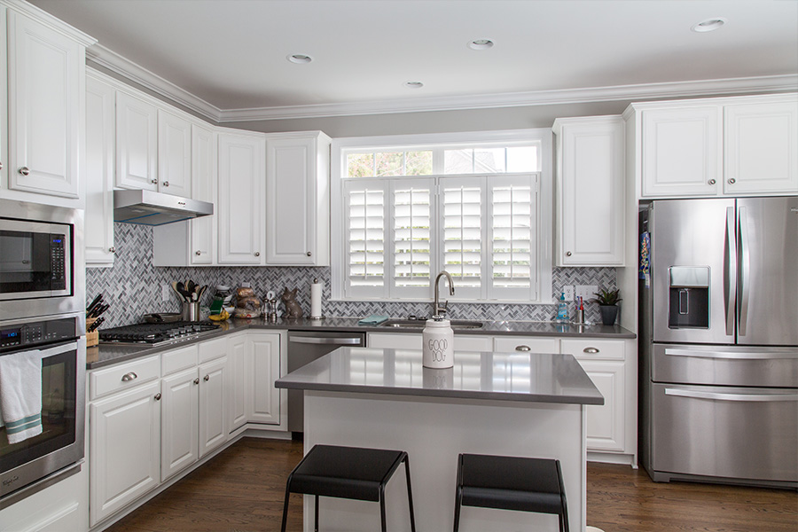 Put Polywood shutters on your kitchen sink window and never worry about water, steam, or splatters destroying them. White Polywood shutters on a window over a kitchen sink