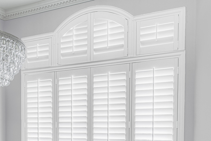 Customize your Palladian windows with white Polywood shutters in Atlanta. White Polywood Palladian windows in a dining room.