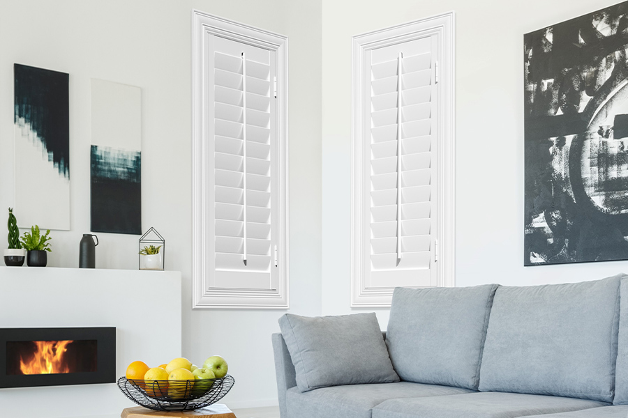 White Polywood shutters add character and class in Atlanta. White polywood shutters in a corner of a modern living room.